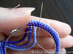 Weave both ends of the thread through a couple of beads to bury the knots and cut as close to the beads as possible