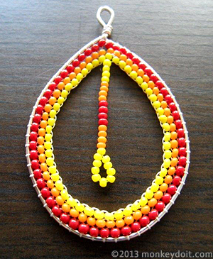 Loop earring decorated with beads on the inside 